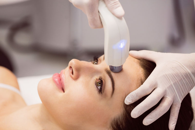 Q-Switch laser toning treatment on a patient's face at Clinic Next Face